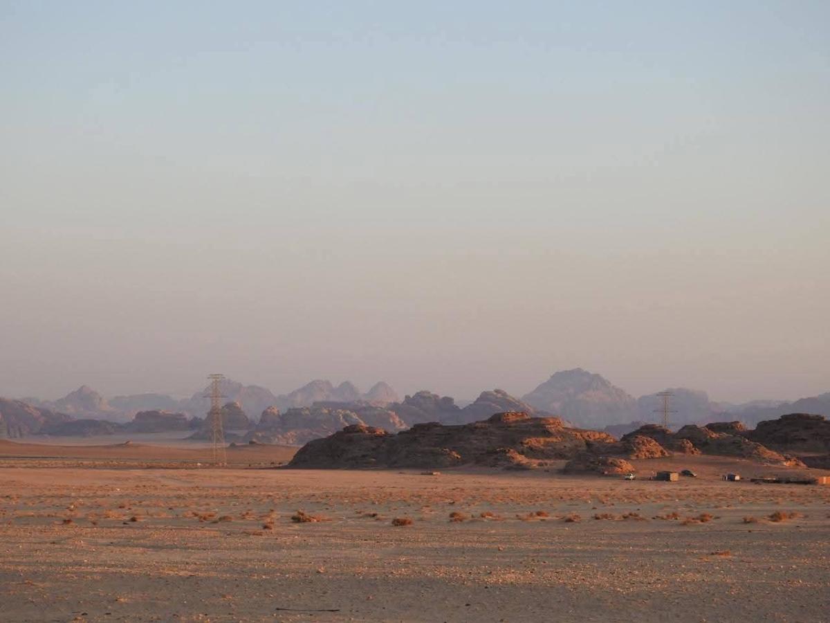 A desert landscape with mountains in the background</p>
<p>AI-generated content may be incorrect.