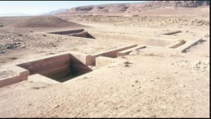 A large rectangular structure in the desert</p>
<p>AI-generated content may be incorrect.