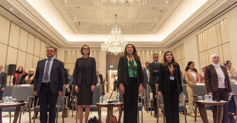  Panel attendees rise for the Jordanian national anthem.