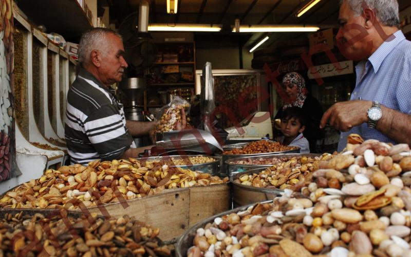 مواطن يشتري المكسرات من محل بوسط البلد- عدسة منى عمري 