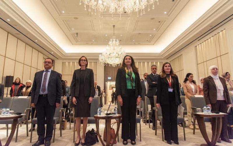  Panel attendees rise for the Jordanian national anthem.